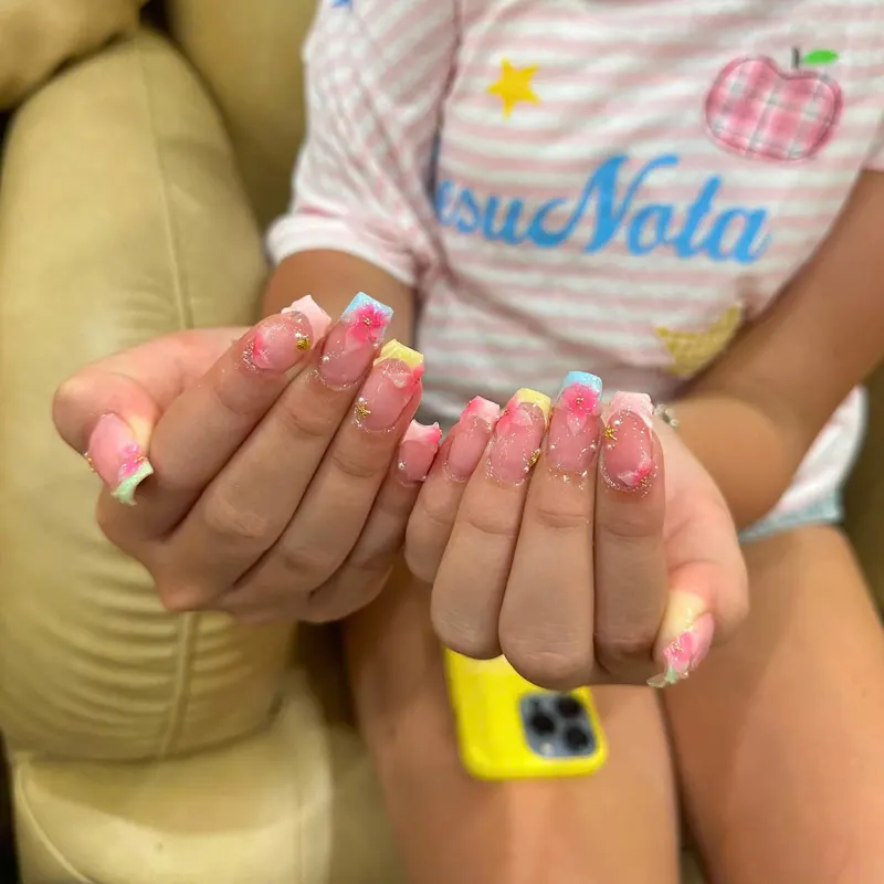 Pink French nails with yellow flower art by LENA Nails & Beauty, nail salon in Da Nang