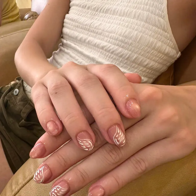 Nude nails with white leaf art by LENA Nails & Beauty, nail salon in Da Nang