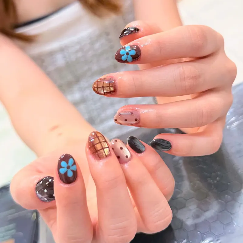 Nails with blue flower, tartan and polka dot art by LENA Nails & Beauty, nail salon in Da Nang