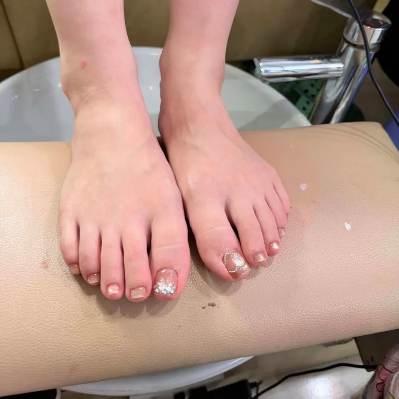 Nude pedicure with silver glitter accent by LENA Nails & Beauty, nail salon in Da Nang