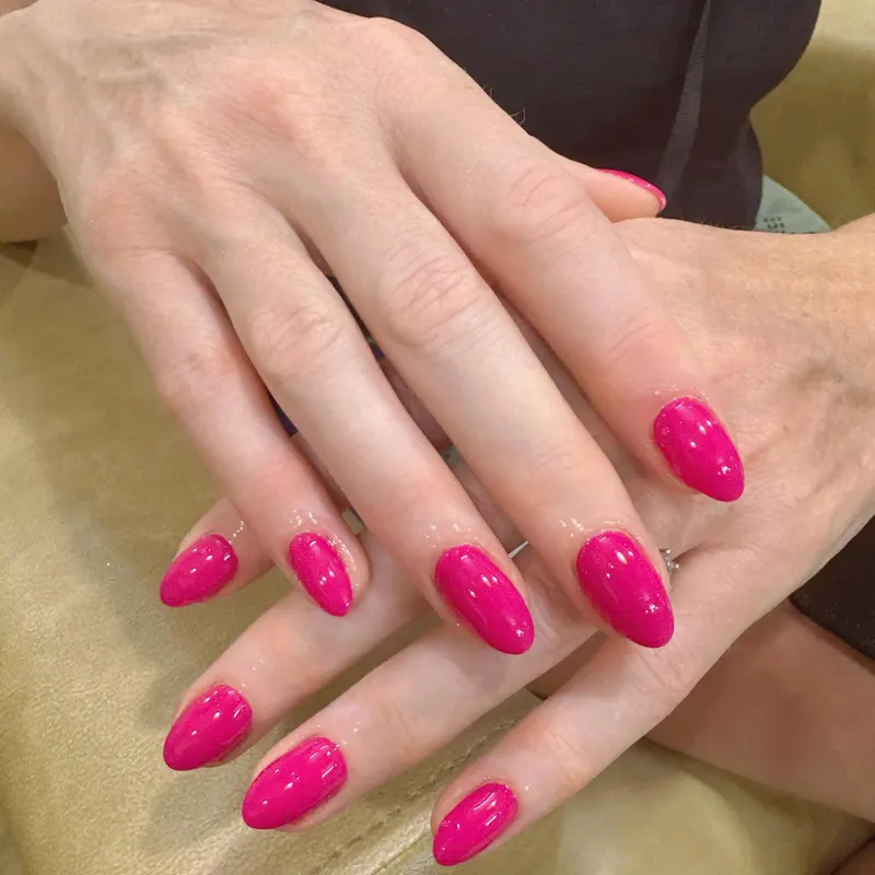 Glossy hot pink almond nails by LENA Nails & Beauty, nail salon in Da Nang