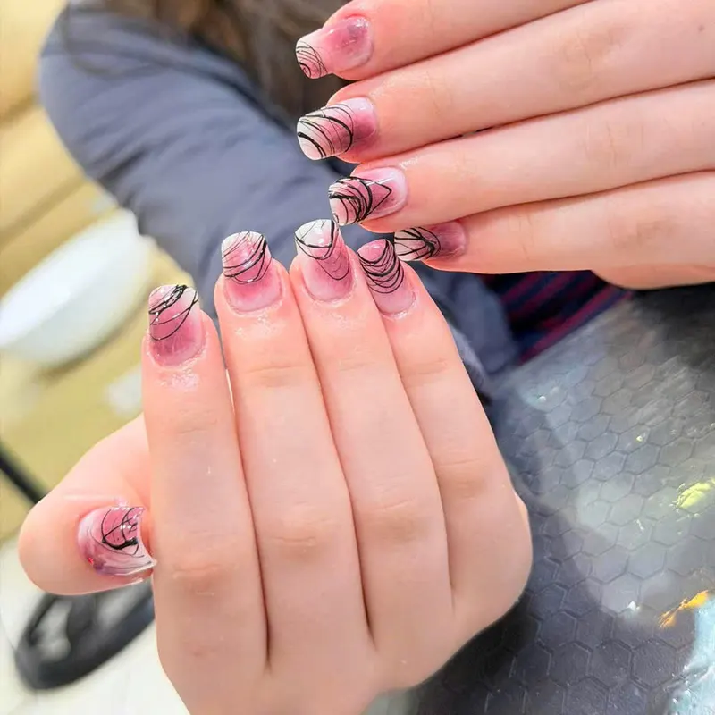 Nude nails with black swirl line art by LENA Nails & Beauty, nail salon in Da Nang