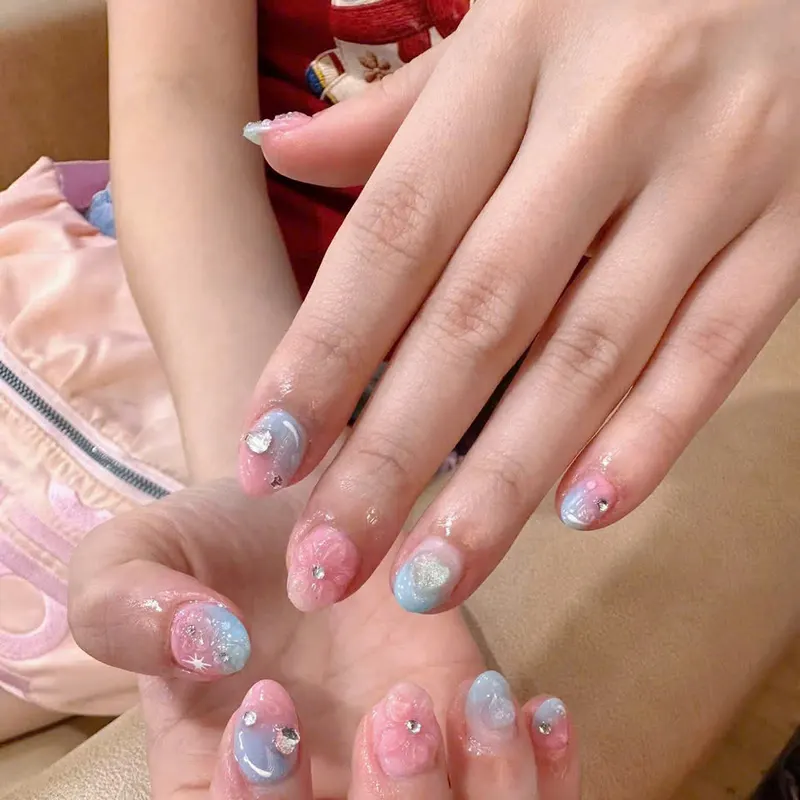 Pastel pink and blue nails with 3D charms by LENA Nails & Beauty, nail salon in Da Nang