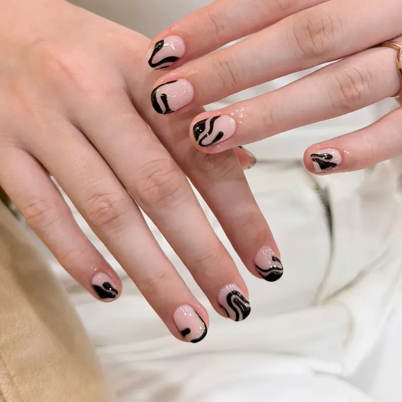 Nude nails with black abstract line art by LENA Nails & Beauty, nail salon in Da Nang